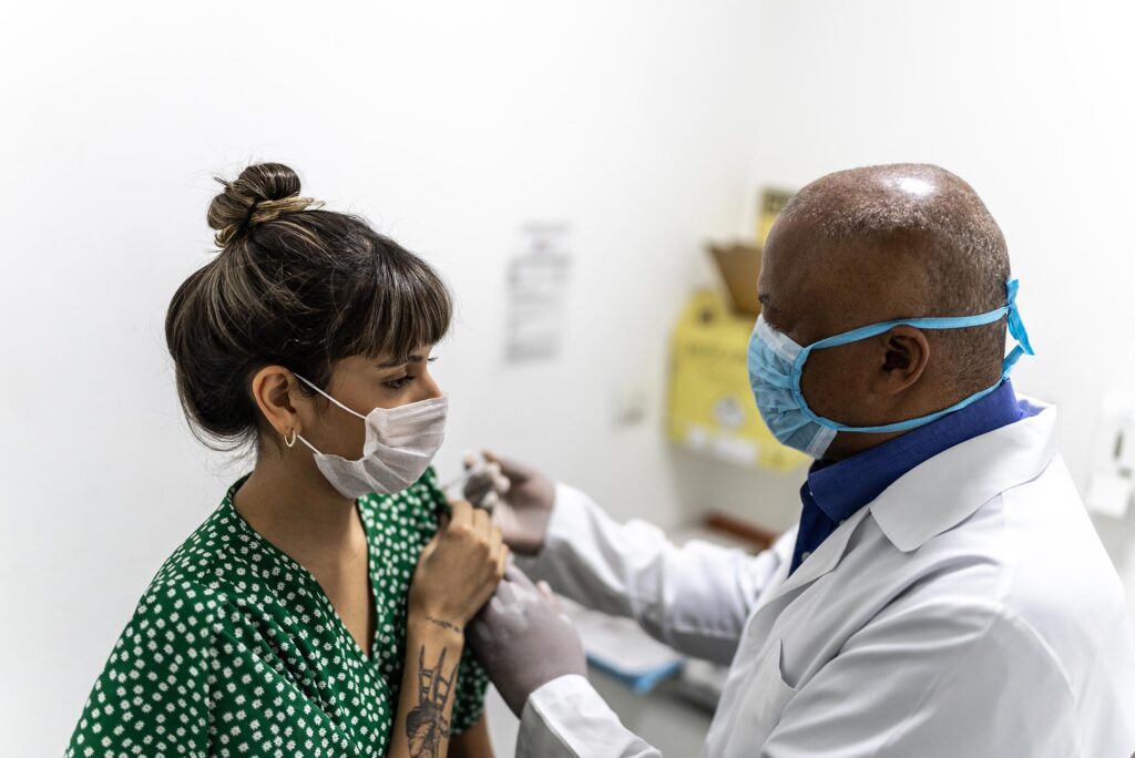 Young woman getting vaccinated at a pharmacy